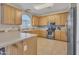 Bright kitchen featuring light wood cabinetry, stainless steel appliances, and tile flooring at 40613 N Jerlyn Pl, San Tan Valley, AZ 85140