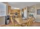 Inviting kitchen and dining area with wood table and chairs, bar seating, and stainless steel appliances at 40613 N Jerlyn Pl, San Tan Valley, AZ 85140