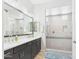 Well-lit bathroom with double vanity, dark cabinets, and glass-enclosed shower at 4164 E Bernice St, Gilbert, AZ 85295