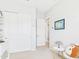White bedroom with closet, door, map art, and white accents at 4164 E Bernice St, Gilbert, AZ 85295