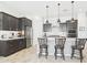 Well-lit kitchen featuring an island with seating, stainless steel appliances, and ample counter space at 4164 E Bernice St, Gilbert, AZ 85295