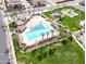 Aerial view of sparkling pool with lounge chairs, palm trees, and nearby community recreational facilities at 4164 E Bernice St, Gilbert, AZ 85295
