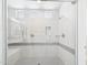 Modern shower with white tile surround, gray accent tile, and glass door at 4164 E Bernice St, Gilbert, AZ 85295
