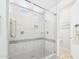 Luxurious tiled shower with glass enclosure, rainfall showerhead, and built-in niche at 4164 E Bernice St, Gilbert, AZ 85295