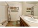 Well-lit bathroom featuring a shower-tub combo and vanity with storage space at 42370 W Hillman Dr, Maricopa, AZ 85138