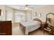 Comfortable bedroom with soft lighting, vintage furnishings and large windows at 42370 W Hillman Dr, Maricopa, AZ 85138