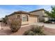 Charming single-story home featuring a two-car garage and desert landscaping at 42370 W Hillman Dr, Maricopa, AZ 85138