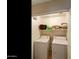 Efficient laundry room equipped with a washer, dryer, and shelving for storage at 42370 W Hillman Dr, Maricopa, AZ 85138