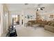 Inviting living room with an open concept, carpeted floors, and sliding door to patio at 42370 W Hillman Dr, Maricopa, AZ 85138