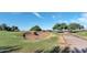 Golf course sand trap with lush green surroundings, mature trees, and a paved cart path at 42370 W Hillman Dr, Maricopa, AZ 85138