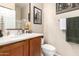 Bright bathroom features wood vanity, framed mirror and neutral colored walls at 42424 N Gavilan Peak Pkwy # 63212, Anthem, AZ 85086