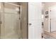 This bathroom features glass enclosed shower and open doorway to another room at 42424 N Gavilan Peak Pkwy # 63212, Anthem, AZ 85086