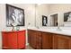 Stylish bathroom with a double vanity, wood cabinets, and unique artistic accents at 42424 N Gavilan Peak Pkwy # 63212, Anthem, AZ 85086