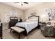 Cozy bedroom features elegant bed with tufted headboard, and sophisticated decor at 42424 N Gavilan Peak Pkwy # 63212, Anthem, AZ 85086
