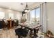 A naturally lit dining area with a decorative table set, bar stools, and a view to the outside at 42424 N Gavilan Peak Pkwy # 63212, Anthem, AZ 85086