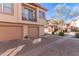 Exterior of a two-story home with two car garage, desert landscaping, and a brick paved driveway at 42424 N Gavilan Peak Pkwy # 63212, Anthem, AZ 85086