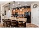 Spacious kitchen with a large island, wooden cabinets, stainless steel appliances, and stylish pendant lighting at 42424 N Gavilan Peak Pkwy # 63212, Anthem, AZ 85086