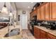 Open kitchen featuring wood cabinets, a large island with a sink, and modern appliances at 42424 N Gavilan Peak Pkwy # 63212, Anthem, AZ 85086