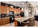 A kitchen features granite countertops, a stainless steel sink, and a black refrigerator and oven at 42424 N Gavilan Peak Pkwy # 63212, Anthem, AZ 85086