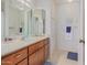 Well-lit bathroom featuring a large mirror, plenty of storage, and sleek countertop at 425 S Parkcrest Dr # 334, Mesa, AZ 85206