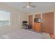 Comfortable bedroom featuring a large window, dresser, TV, and spacious closets at 425 S Parkcrest Dr # 334, Mesa, AZ 85206