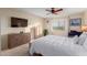 Well-lit bedroom with large bed, window, dresser, chest of drawers, and TV for optimal relaxation at 425 S Parkcrest Dr # 334, Mesa, AZ 85206