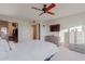 Bright bedroom featuring large bed, television, chest of drawers, and open closet for optimal storage at 425 S Parkcrest Dr # 334, Mesa, AZ 85206