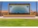 Outdoor stage with a desert landscape mural, offering a charming venue for community events at 425 S Parkcrest Dr # 334, Mesa, AZ 85206