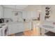 Bright kitchen features white cabinets and appliances, alongside a convenient washer and dryer at 425 S Parkcrest Dr # 334, Mesa, AZ 85206