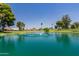 Scenic pond with a water fountain surrounded by lush greenery and beautiful homes at 425 S Parkcrest Dr # 334, Mesa, AZ 85206