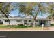 Inviting single-story house featuring a lush lawn, mature trees, and an attached carport at 4332 E Calle Redonda St, Phoenix, AZ 85018