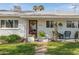Inviting front porch featuring a decorative wreath, potted plants, and comfortable seating area at 4332 E Calle Redonda St, Phoenix, AZ 85018