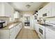 A kitchen area featuring white cabinets, stainless sink, and tile flooring at 4332 E Calle Redonda St, Phoenix, AZ 85018