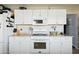 Kitchen features white cabinets and appliances with updated countertops at 4332 E Calle Redonda St, Phoenix, AZ 85018