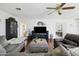 Well-lit living room with hardwood floors, comfortable seating, and a mounted television at 4332 E Calle Redonda St, Phoenix, AZ 85018