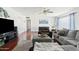 Bright living room featuring hardwood floors, comfortable gray furniture, and natural light at 4332 E Calle Redonda St, Phoenix, AZ 85018