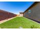 Lush backyard featuring well-maintained artificial grass, enclosed by a privacy fence, for relaxation and recreation at 45975 W Mountain View Rd, Maricopa, AZ 85139