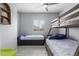Bedroom with a ceiling fan, bunk beds, and tile floors at 45975 W Mountain View Rd, Maricopa, AZ 85139