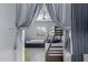 Cozy bedroom with bunk beds, tile floors, ceiling fan, and ample natural light at 45975 W Mountain View Rd, Maricopa, AZ 85139