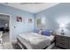 Bedroom with blue walls, a window with blinds, and a comfortable bed with pillows at 45975 W Mountain View Rd, Maricopa, AZ 85139