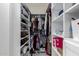 Walk-in closet with organized shelving, hanging clothes, and storage solutions at 45975 W Mountain View Rd, Maricopa, AZ 85139