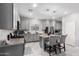Well-lit kitchen boasts granite countertops, stainless steel appliances, and an island with seating at 45975 W Mountain View Rd, Maricopa, AZ 85139