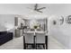 Open kitchen boasts stainless steel appliances and a dining area with modern lighting at 45975 W Mountain View Rd, Maricopa, AZ 85139