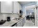 Well-equipped kitchen with stainless steel sink, modern cabinets, and a view into the dining and living areas at 45975 W Mountain View Rd, Maricopa, AZ 85139