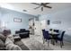 Inviting living room featuring a dining area, piano, and plush gray sofa at 45975 W Mountain View Rd, Maricopa, AZ 85139