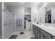 Modern main bathroom featuring a large double sink vanity, step-in shower, and spacious walk-in closet at 45975 W Mountain View Rd, Maricopa, AZ 85139