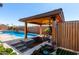 Outdoor kitchen with a built-in grill, sink, and bar, offering the ultimate outdoor living and entertaining experience at 45975 W Mountain View Rd, Maricopa, AZ 85139