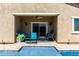Covered patio offers an ideal space for relaxation, adjacent to the inviting pool, complete with comfortable seating at 45975 W Mountain View Rd, Maricopa, AZ 85139