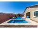 Beautiful pool with a built-in spa, sun shelf, and a covered outdoor living area in the backyard at 45975 W Mountain View Rd, Maricopa, AZ 85139