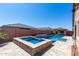 Beautiful pool with a built-in spa, and a covered outdoor living area in the backyard at 45975 W Mountain View Rd, Maricopa, AZ 85139